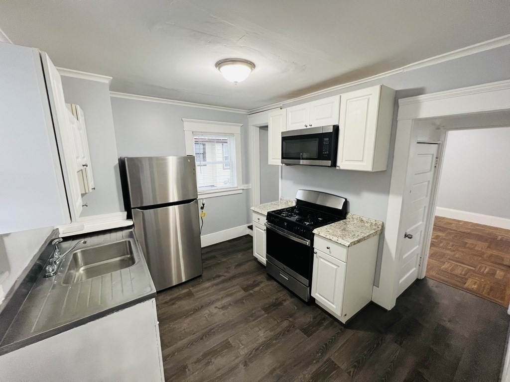 781 White Street Springfield, MA 01108 - Photo 11 of 25 a kitchen with a stove a refrigerator and a sink
