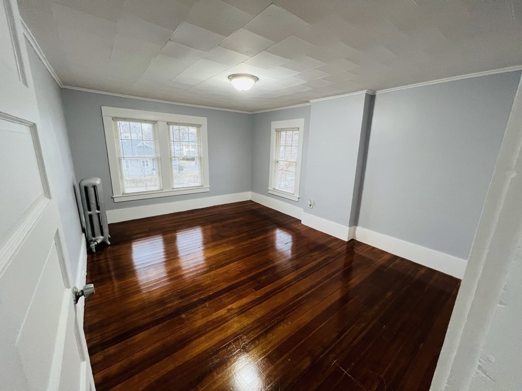 781 White Street Springfield, MA 01108 - Photo 15 of 25 wooden floor in an empty room with a window