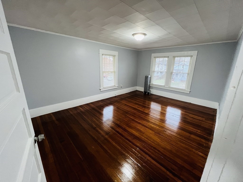 781 White Street Springfield, MA 01108 - Photo 16 of 25 wooden floor in an empty room with a window