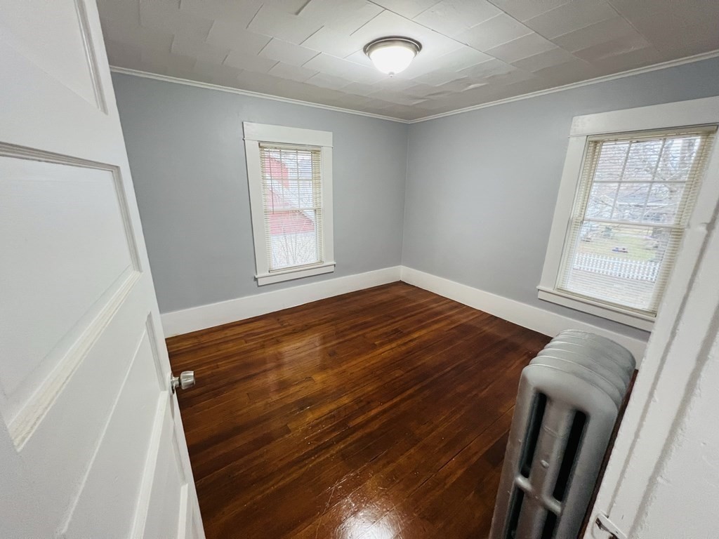 781 White Street Springfield, MA 01108 - Photo 17 of 25 a view of an empty room with wooden floor and a window