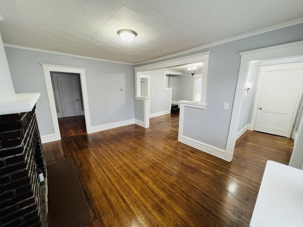 781 White Street Springfield, MA 01108 - Photo 4 of 25 wooden floor in an empty room with a fireplace