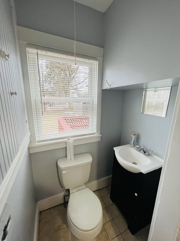 781 White Street Springfield, MA 01108 - Photo 8 of 25 a bathroom with a sink a toilet and a window
