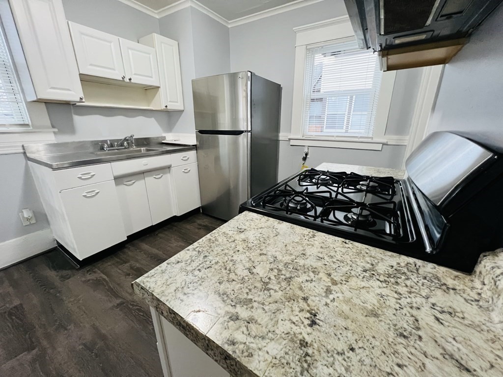 781 White Street Springfield, MA 01108 - Photo 10 of 25 a kitchen with white cabinets and a stove