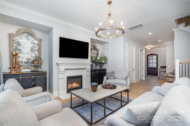 a living room with furniture a flat screen tv and a fireplace