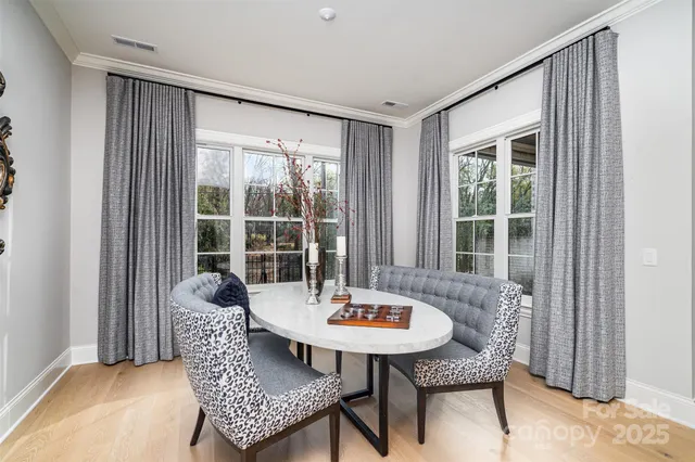 a view of a room with a table and chairs