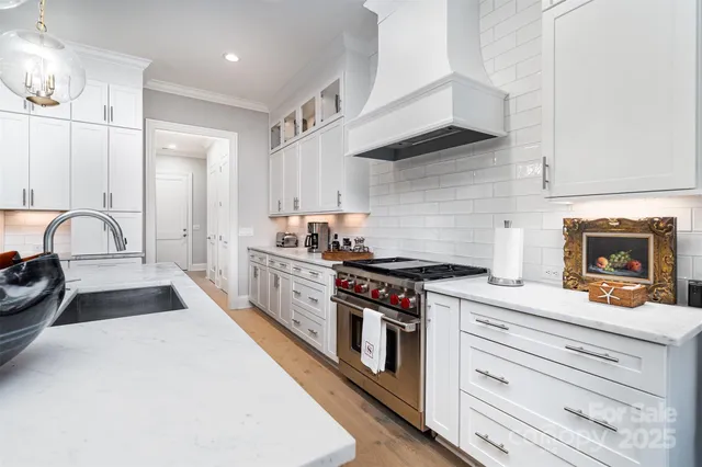 a kitchen with stainless steel appliances granite countertop a stove and a sink