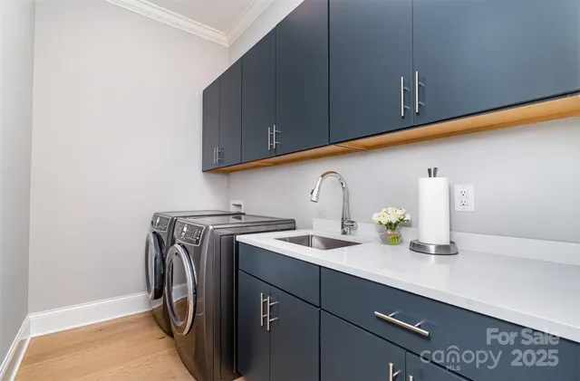 a utility room with sink dryer and washer
