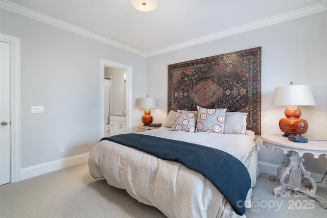 a bedroom with a bed and lamp with table