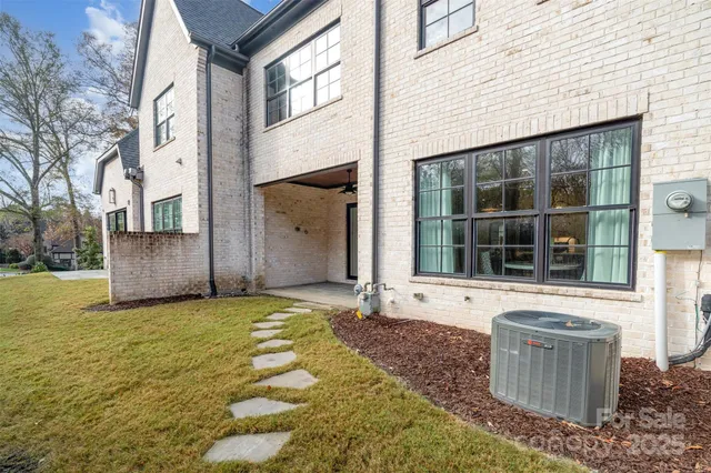 a front view of a house with large windows and a fireplace