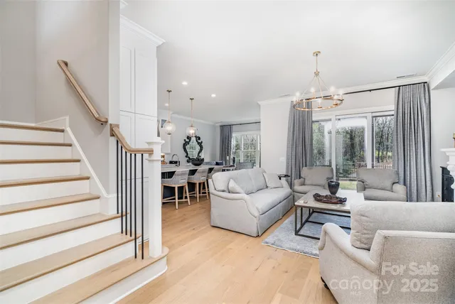 a living room with furniture and a chandelier