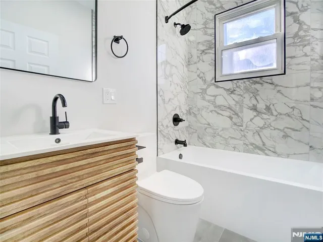 a bathroom with a sink a toilet and a bathtub