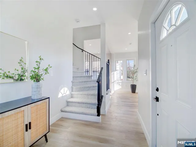 a view of entryway and hall with wooden floor