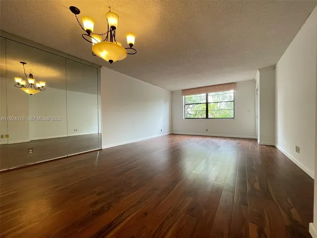 a view of room with wooden floor