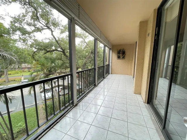 a view of a balcony with wooden floor