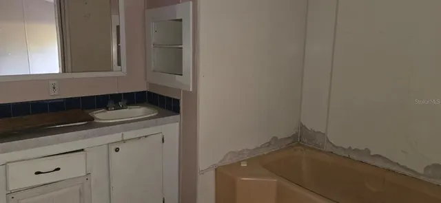 a bathroom with a sink and cabinets