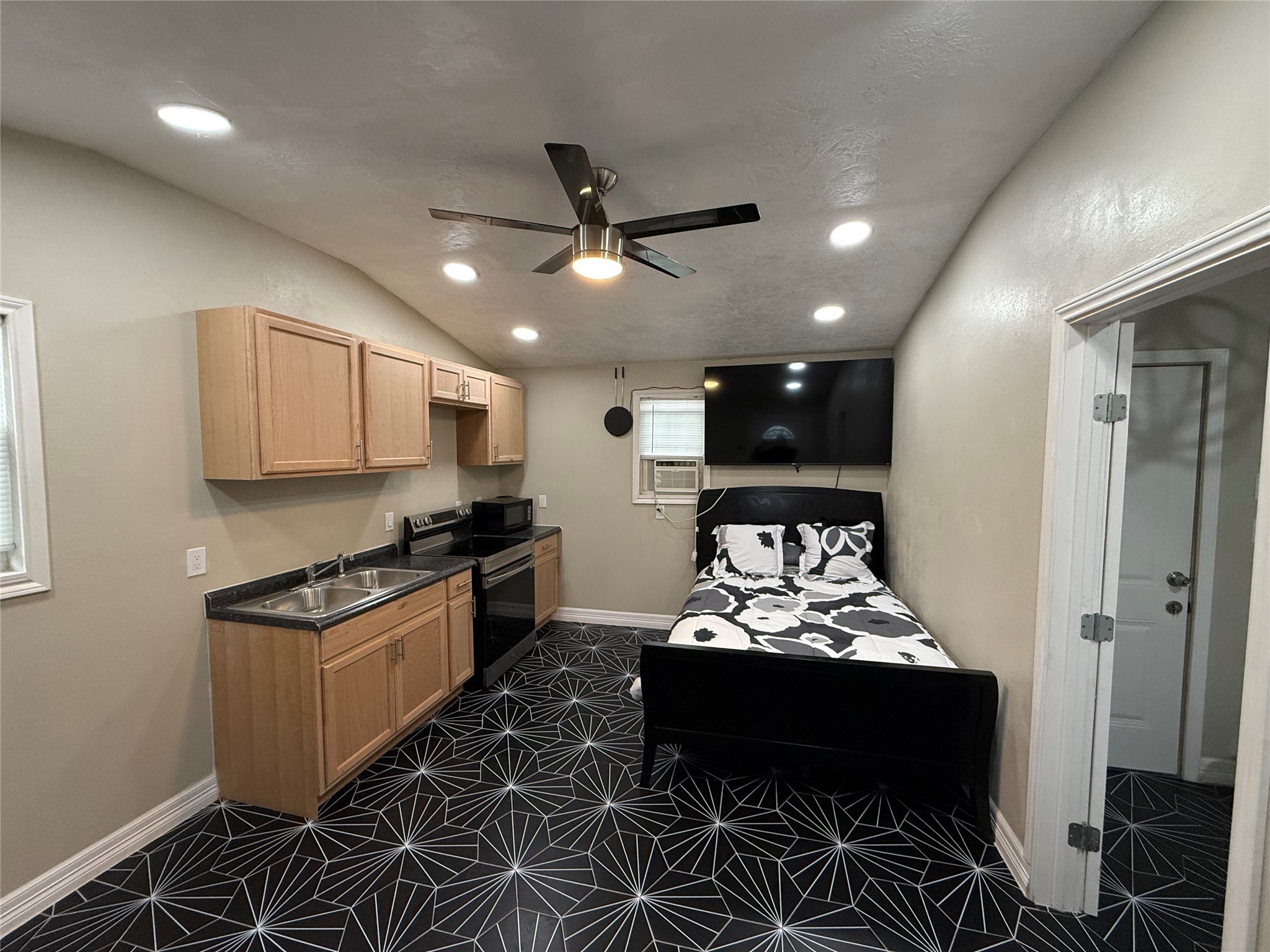 3310 Vega Houston, TX 77088 - Photo 3 of 8 a kitchen with granite countertop a stove a sink and a refrigerator