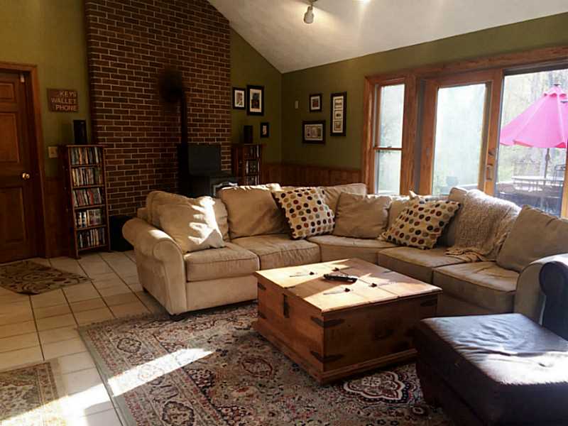 141 Franklin Road Scituate, RI 02825 - Photo 5 of 25 Den/Family/Great Room. What a room! This great/family room features tile flooring, pellet stove for those cold nights. Very spacious room. Door towards left leads out to garage, which has a full size loft.