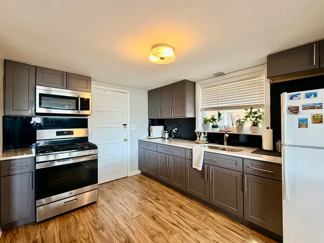 a kitchen with a sink stove and microwave