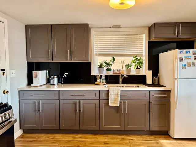 a kitchen with a cabinets a counter top space and cabinets