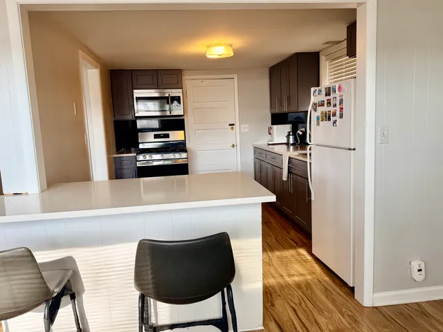 a kitchen with stainless steel appliances a refrigerator and microwave