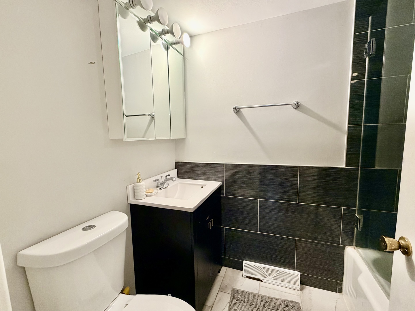 7238 West Crain Street, Unit G Niles, IL 60714 - Photo 9 of 11 a bathroom with a sink toilet and shower