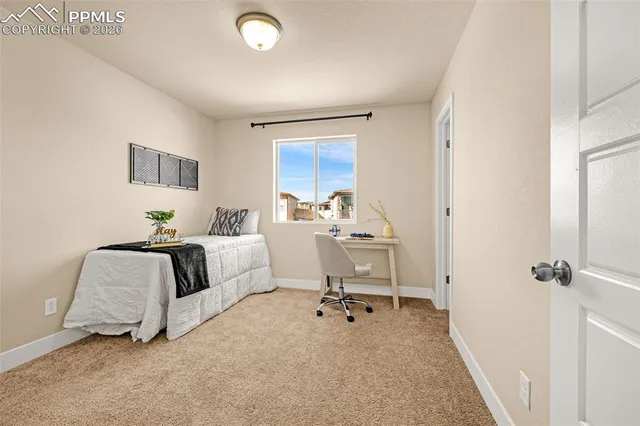 a bed room with a bed and a chair