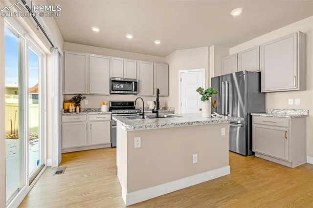 a kitchen with a sink stove and refrigerator