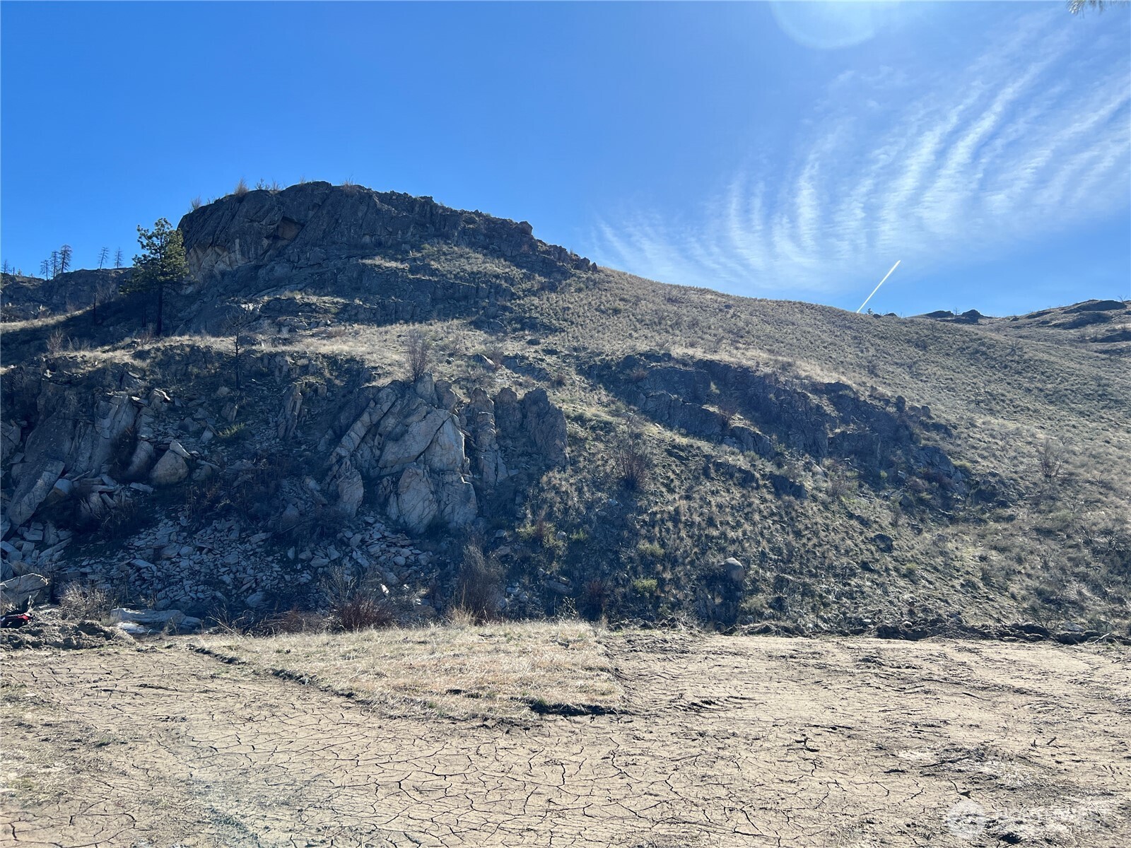 -nna Nna Soap Lake Road Okanogan, WA 98840 - Photo 8 of 15 a view of a dry yard with a mountain in the background