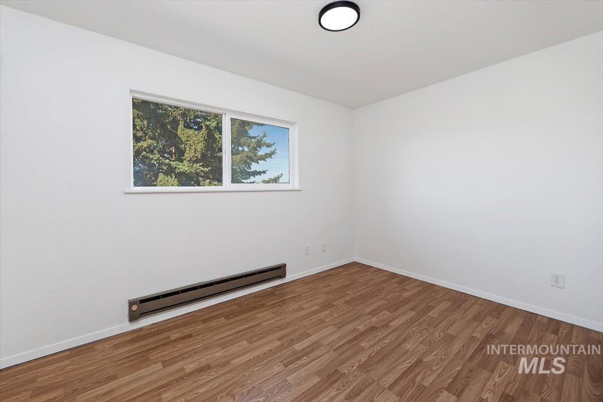 259 Pheasant Road, Unit 84 Twin Falls, ID 83301 - Photo 18 of 25 Room featuring wood-finish flooring, white baseboards, and a window offering natural light