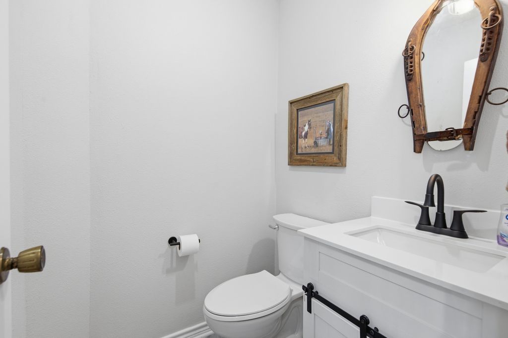 1454 Red Town Road Elgin, TX 78621 - Photo 16 of 40 A well-appointed powder room features a sleek vanity and modern fixtures.