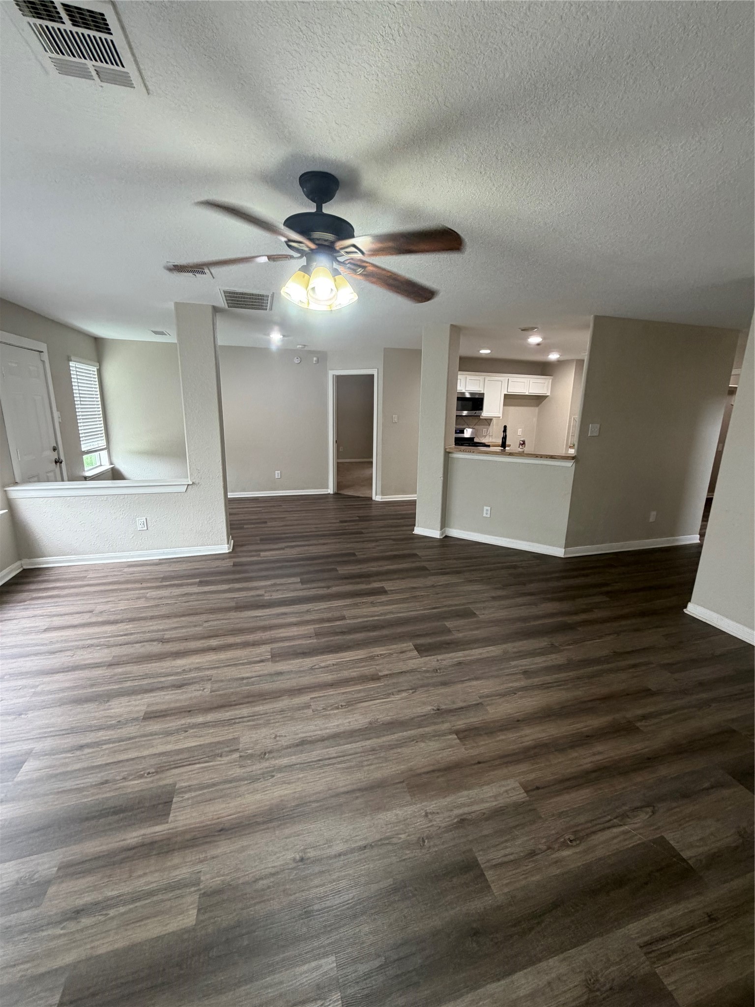 3219 Watercliff Court Spring, TX 77388 - Photo 3 of 21 a view of an empty room with wooden floor and a ceiling fan