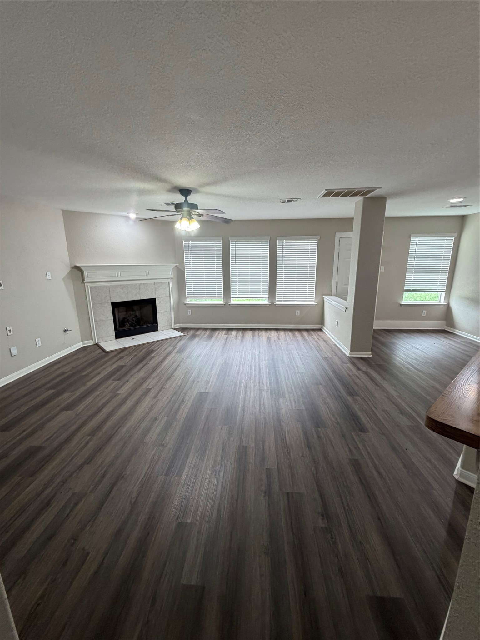 3219 Watercliff Court Spring, TX 77388 - Photo 4 of 21 an empty room with wooden floor fireplace and windows
