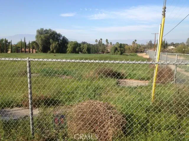 a view of a field with an trees in the background