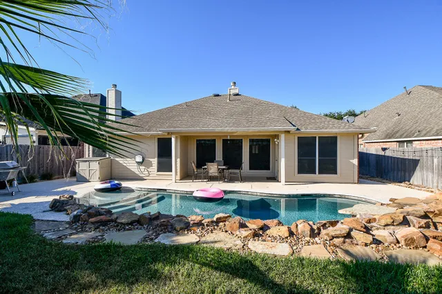 a front view of a house with swimming pool and porch