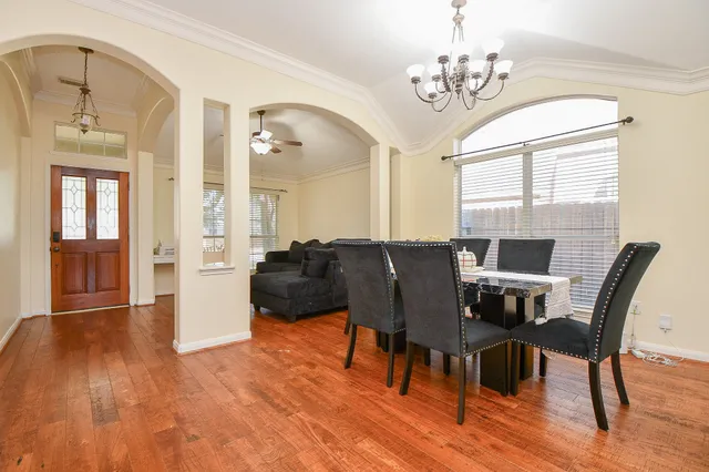 a view of a dining room with furniture and wooden floor