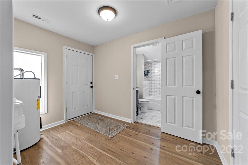 1025 Stone Road Salisbury, NC 28146 - Photo 14 of 47 an empty room with wooden floor cabinet and windows