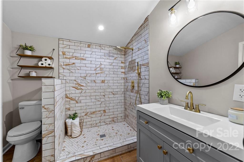 1025 Stone Road Salisbury, NC 28146 - Photo 19 of 47 a bathroom with a granite countertop toilet sink and mirror