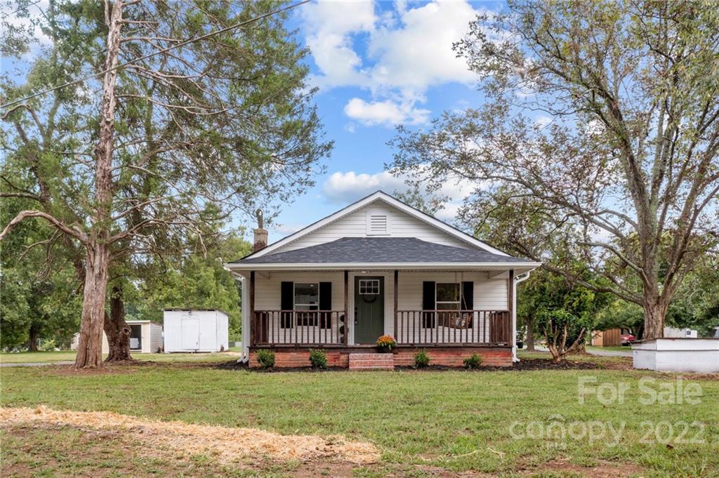 1025 Stone Road Salisbury, NC 28146 - Photo 26 of 47 a front view of a house with a garden and trees