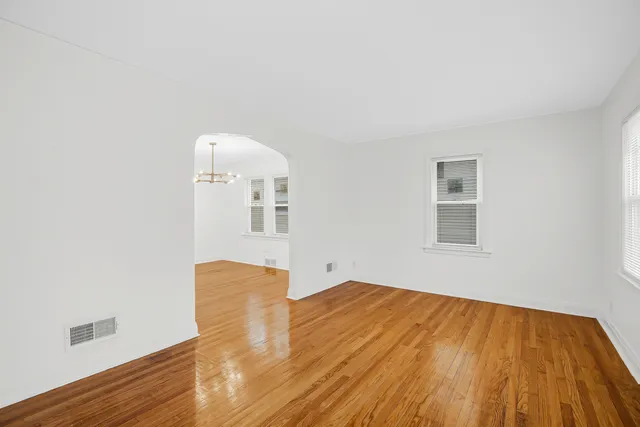 a view of a room with wooden floor and white walls