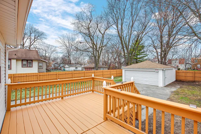 a view of balcony with wooden floor and fence