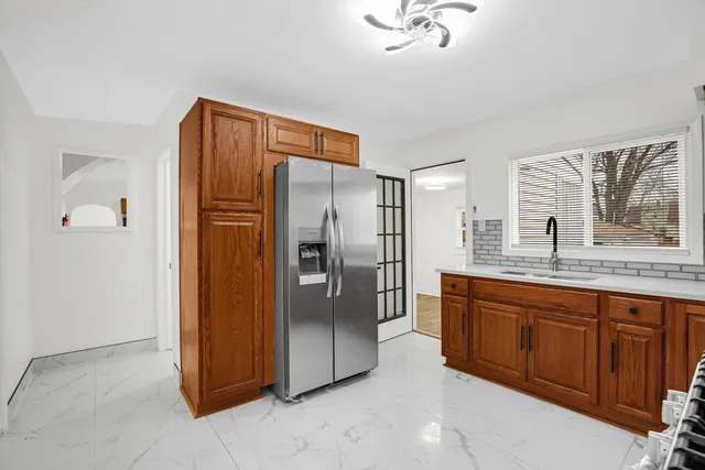 a kitchen with stainless steel appliances granite countertop a refrigerator and a sink