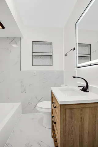 a bathroom with a sink toilet and vanity