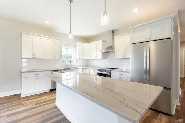 a kitchen with stainless steel appliances granite countertop a sink stove and cabinets