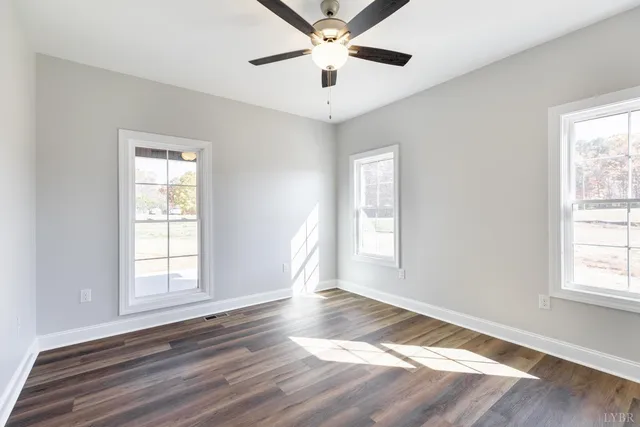 wooden floor in an empty room with a window
