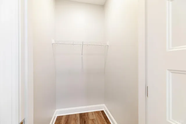 an empty room with windows and ceiling fan