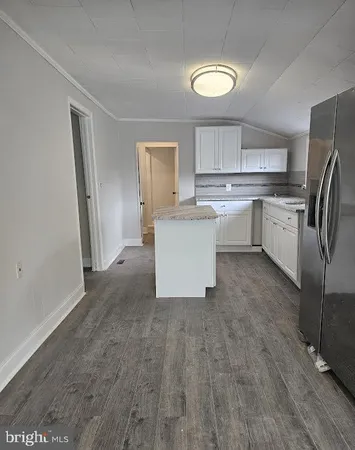 a kitchen with a sink and refrigerator