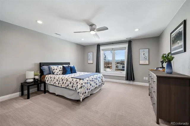 a spacious bedroom with a bed and a chandelier