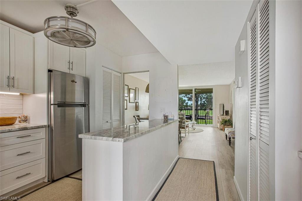 4380 27th Court Southwest, Unit 202 Naples, FL 34116 - Photo 1 of 24 a kitchen with refrigerator and cabinets