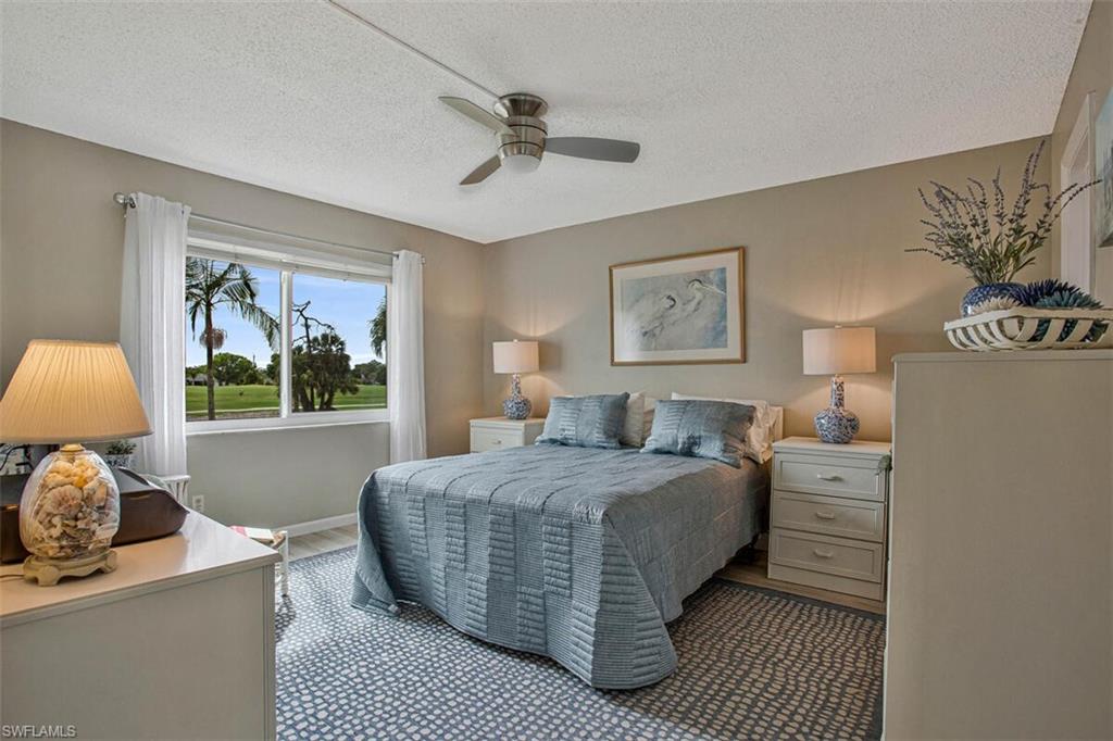 4380 27th Court Southwest, Unit 202 Naples, FL 34116 - Photo 12 of 24 a bedroom with a large bed and a window