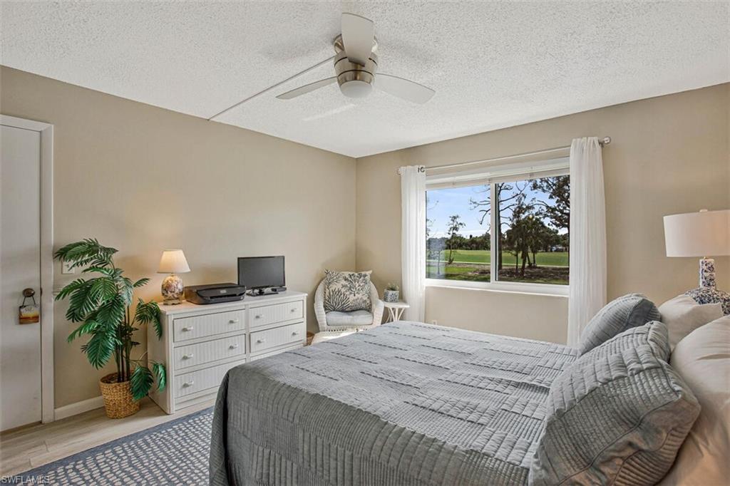 4380 27th Court Southwest, Unit 202 Naples, FL 34116 - Photo 15 of 24 a bed sitting in a bedroom next to a window
